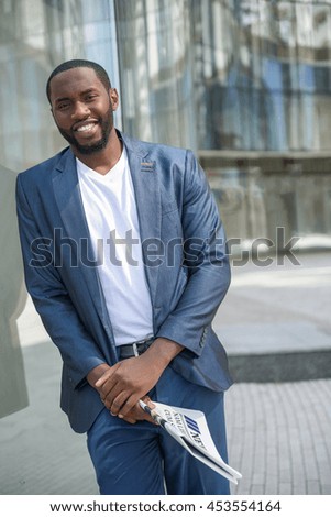 Happy young man with paper in city