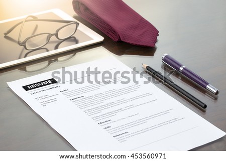 Resume information, with pen, necktie and glasses.