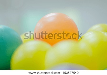 colorful plastic balls in children's playground pool. Intentionally blurred post production for soft focus image and pastel color.