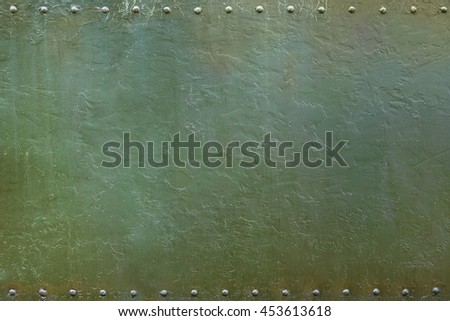 Riveted military or industrial plate. Metal background.