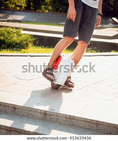 Young man driving on solowheel in the park