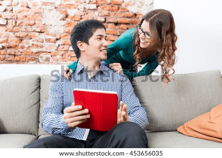 Asian man sit on coach using tablet woman smile business people casual wear modern office