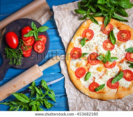 Pizza Margherita on dark wooden background