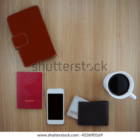 A cup of coffee and texture of smart phone in jeans pocket on wooden background