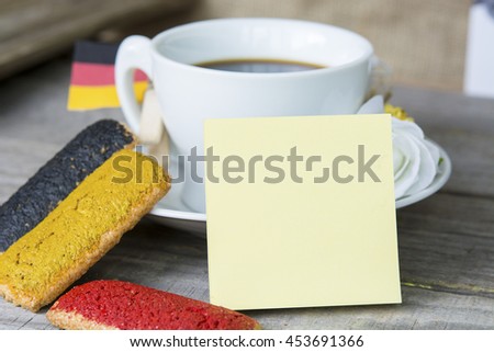 cookies with red black and yellow glaze as the Germany flag colors. cup of coffee and a homemade flag of Germany, decorative patriotic breakfast lunch. Selective focus photo image sticker for text