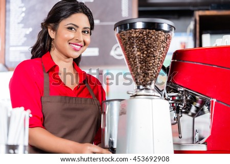 Female barista preparing coffee in Indian Cafe