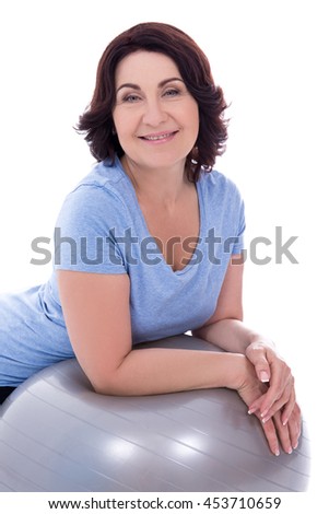 portrait of happy mature woman with fitness ball isolated on white background