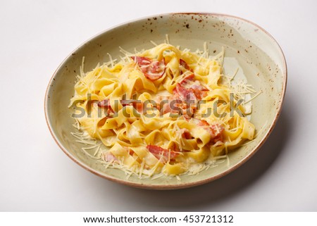 Italian Fettucine carbonara pasta with fried bacon and grated cheese for your food cover menu background Royalty-Free Stock Photo #453721312
