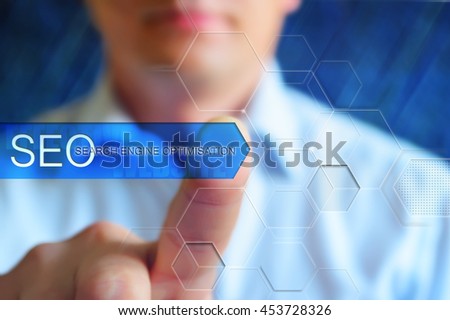 SEO concept image: a person touch virtual button with word "SEO - search engine optimisation", blue background.