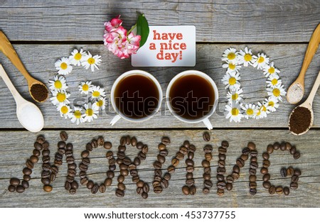 word GOOD from chamomile flowers coffee cups, coffee beans written  morning. lovely message good morning