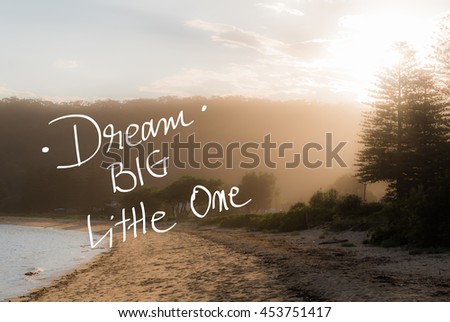 Dream Big Little One message. Handwritten motivational text over sunset calm sunny beach background with vintage filter applied