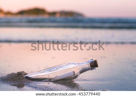 Message in a bottle on the beach. Royalty-Free Stock Photo #453779440