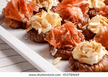 Picture of canapes with cheese and bacon on white background. 