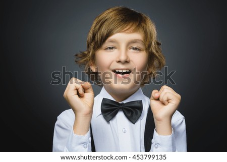 Closeup portrait successful happy boy isolated grey background. Positive human emotion.