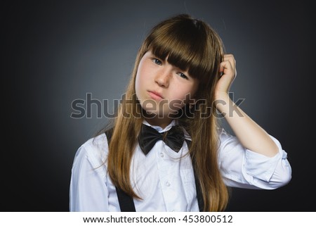 Closeup Thoughtful girl with Hand at head isolated on Gray