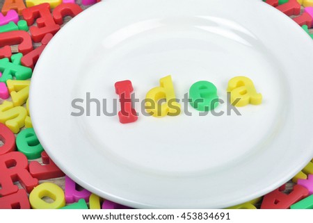 Idea word on white plate and magnetic letters
