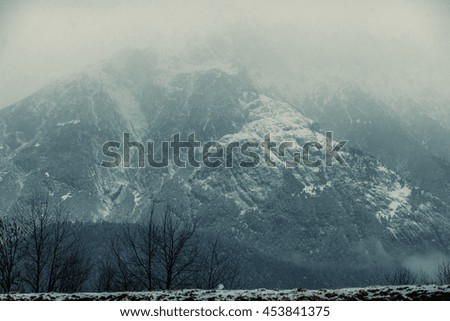 Mighty mountain covered in mist. Great snowy peak. Epic wallpaper. Travel inspiration. Vacation concept. Picture is great for postcard. 
