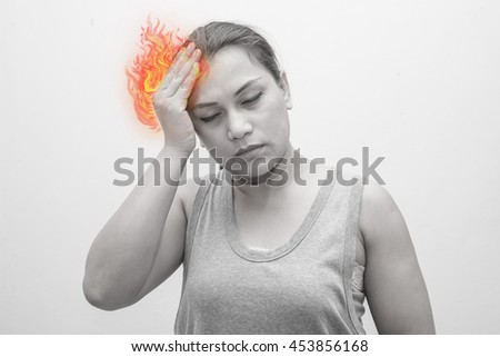 Woman headache - dizziness.Concept photo with Color Enhanced pale skin with Fire indicating location of the pain. 