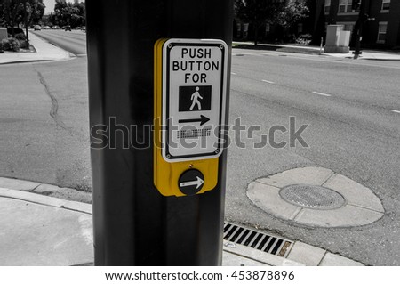 A bright yellow crosswalk sign on a black and white background.