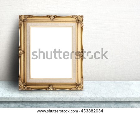 Blank Gold victorian picture frame on white marble table at white tile wall,Template mock up for adding your design and leave space beside frame for adding more text.