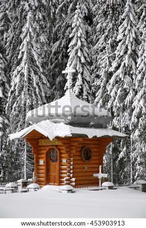 Wooden chapel in a snowy forest.Ukrainian Carpathians, foot of Goverla.