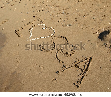 "I love the sea" the inscription on the sand