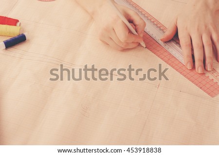 Hand fashion designer develops a sketch of the dress close up