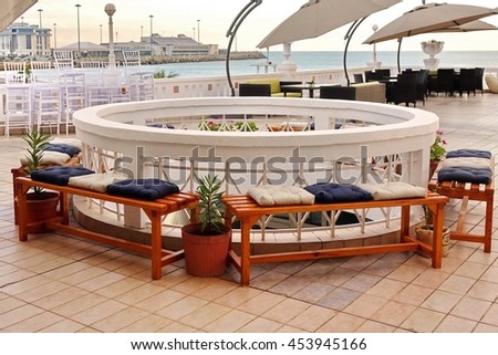 Outdoor Sea View Bar Open Air Terrace Interior With Wooden Furniture And Cafe Parasol