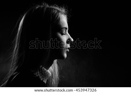 sad girl crying on black background, monochrome