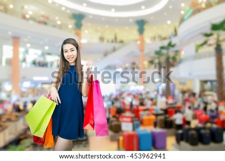 happiness, consumerism, sale and people concept - smiling young woman asian with shopping bags