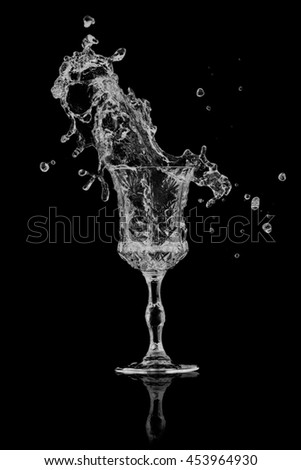 Water splash out of glass on a black background.