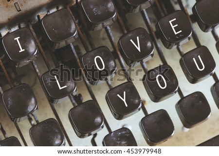 I Love You message written on vintage typewriter keys. Cross processed image with selective focus