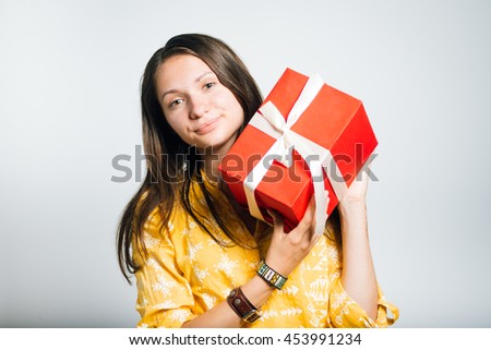 cute girl with packed gift, studio isolated