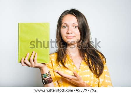 cute girl showing a book, studio isolated