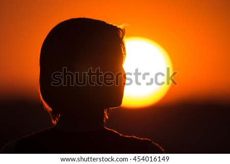 The woman against the background of sunrise