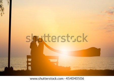 Silhouette picture of the bride and groom wedding over blurred beautiful nature pastel.wedding and lovers concept.
