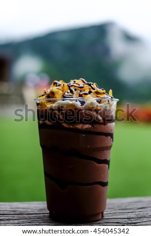 chocolate milkshake topped with chocolate sauce and Corn flakes