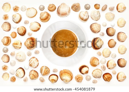 composition of sea shells and a cup of coffee on a white background. top view