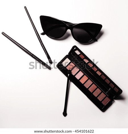 Essentials fashion woman objects on white background. Sunglasses, makeup brushes and makeup palette