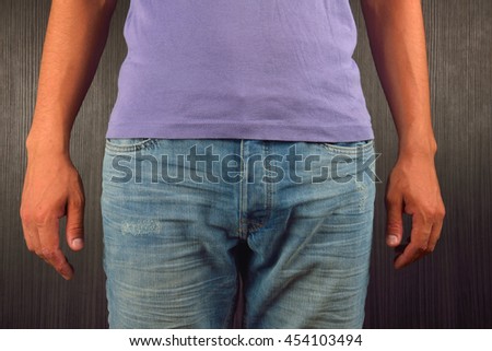 Young man wearing purple blank t-shirt, standing in a studio on dark background. Picture halved. Clothing design concept