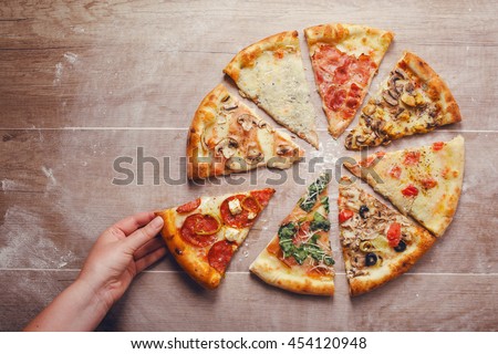 slices of pizza with different toppings on a wooden background

