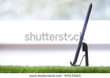 Digital tablet in a grass office. Horizontal photo