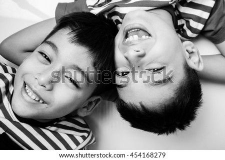 Little sibling boy lay on the pillow together