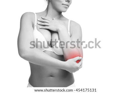 Young caucasian woman in bra with pain in elbow, ache in the human body, isolated on white background with red dot, copy space