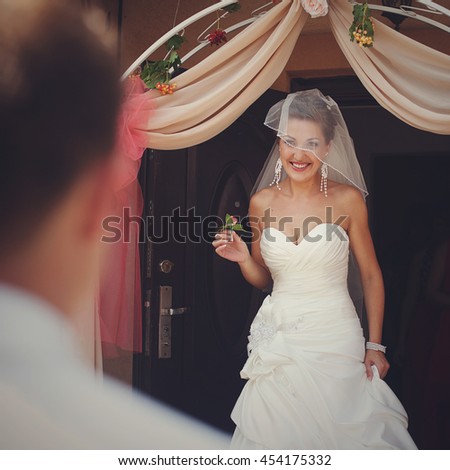 Smiling bride walks out of the house