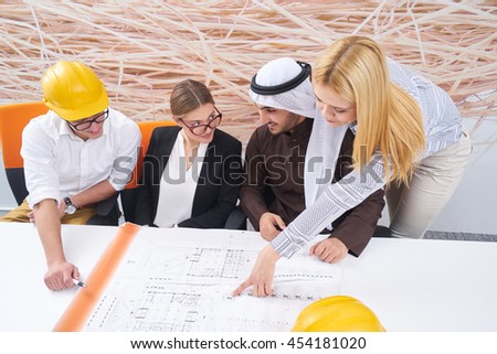 Business team construction engineer architect and worker looking building model and blueprint planbleprint plans