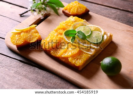 Delicious citrus cake on wooden background