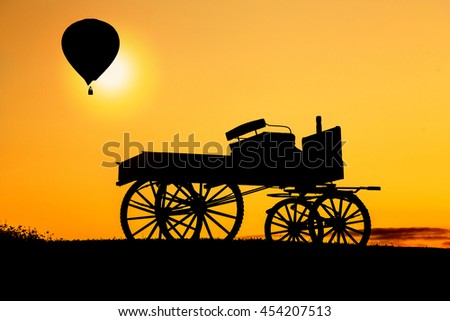  wheel  and Hot air balloon fly up silhouette environment at sunset time