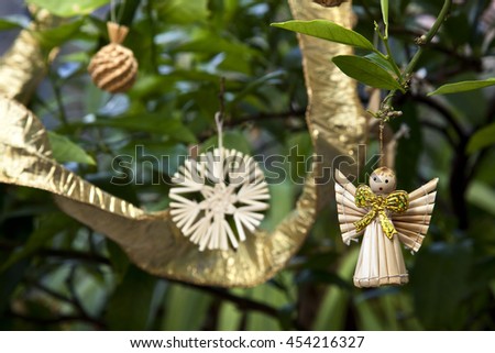 Gold and natural corn Christmas decorations on citrus lemon tree