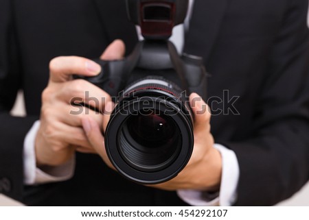 Professional photographer man holding camera with macro len to take photo